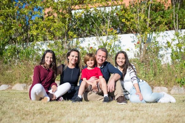A joyful family enjoying sunny moments in a lush Portuguese garden.